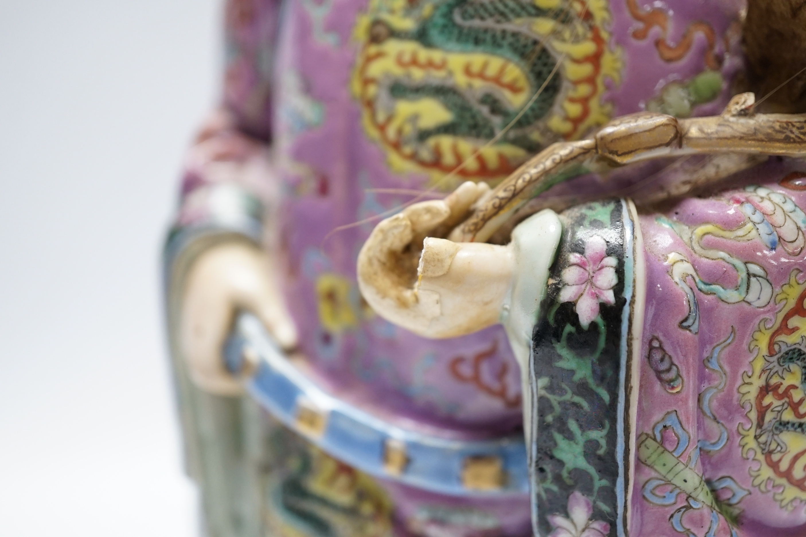 An early 20th century Chinese enamelled porcelain figure of an immortal, 31.5 cm high